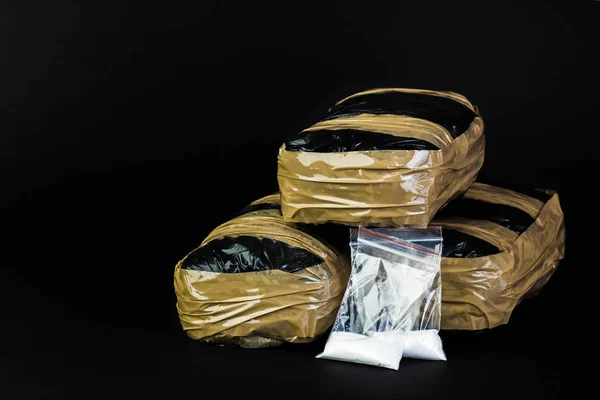 Packages of narcotics isolated on black background. — Stock Photo, Image