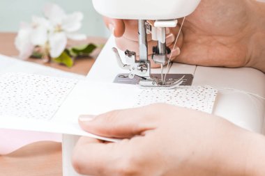 Beyaz dikiş makinesi için çalışan eller. Scrapbooking 