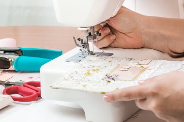 Beyaz dikiş makinesi için çalışan eller. Scrapbooking 