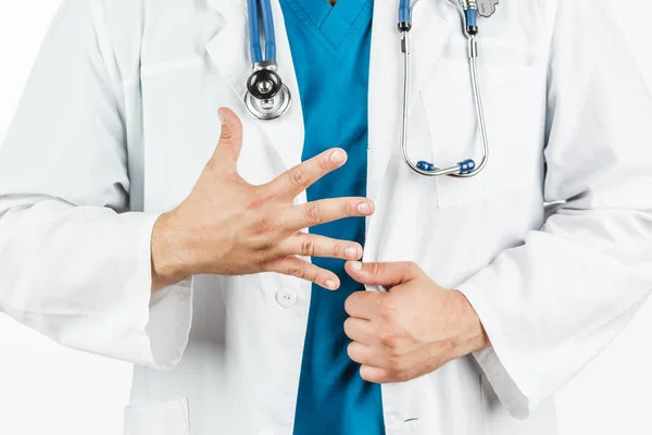 The doctor in a white coat smears his hand number five. — Stock Photo, Image