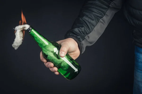 Glass bottle, the so-called Molotov cocktail in the hand of the — Stock Photo, Image