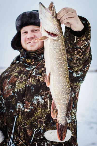 man with snarezheniem goes fishing. winter fishing