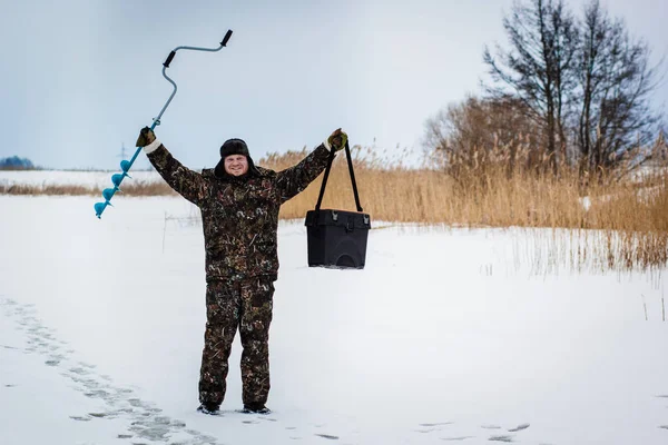 Ice fisherman  on winter lake — Stock Photo, Image