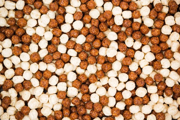 Chocolate breakfast cereal texture. Cereal balls as background.