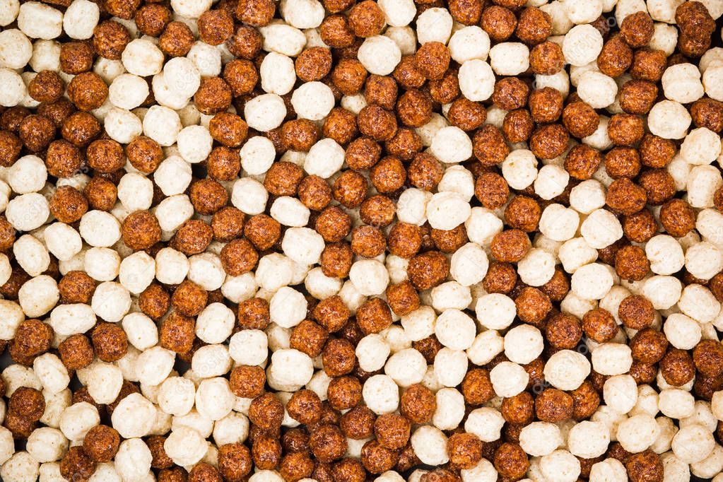 Chocolate breakfast cereal texture. Cereal balls as background. 