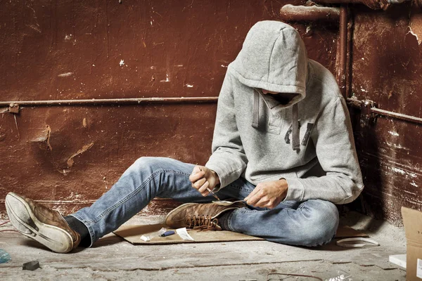 Addict man with a syringe in action. The concept of drug abuse a — Stock Photo, Image