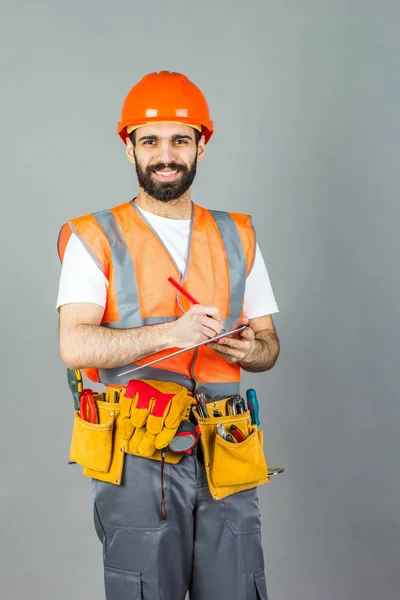 Builder Orange Helmet Gray Background Signs Something — Stock Photo, Image