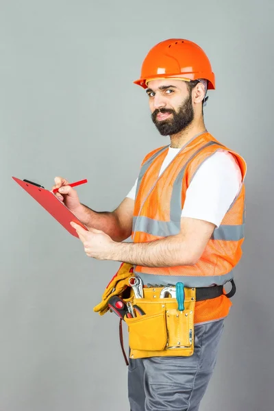 Construtor Capacete Laranja Fundo Cinza Assina Algo — Fotografia de Stock