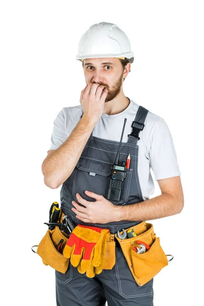 A builder or an employee in a protective helmet is shocked or fr — Stock Photo, Image