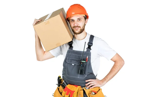 A man is a builder with a cardboard box in his hands. Isolated o — Stock Photo, Image