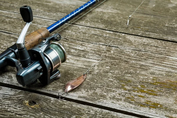 Aparejos de pesca, anzuelos y cebos sobre fondo de madera — Foto de Stock