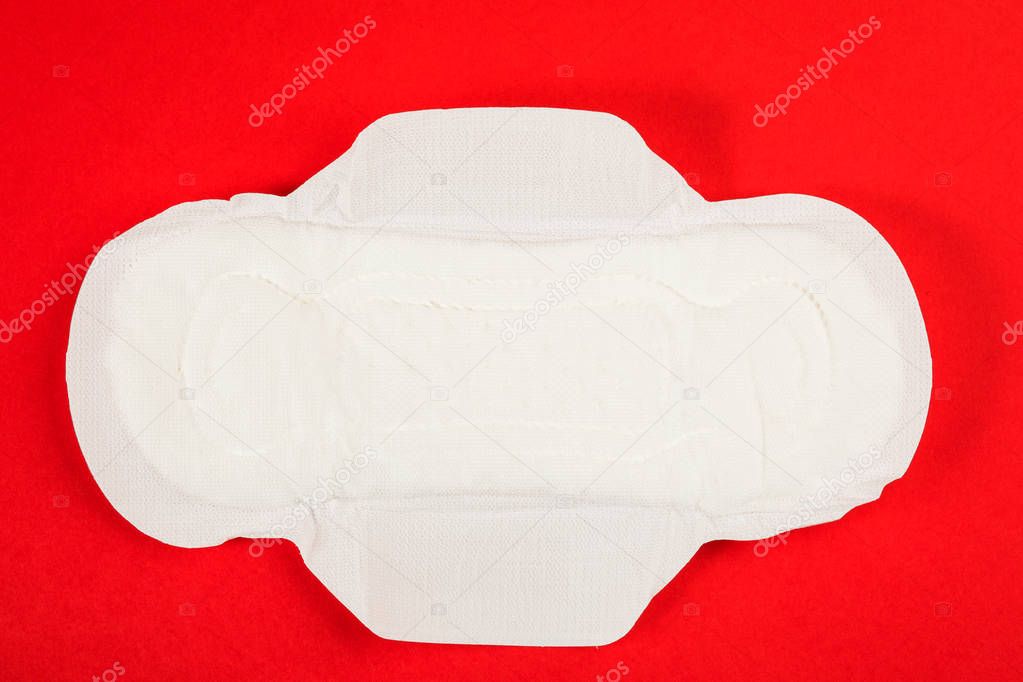 Female feminine hygiene product. White tampons on a red background