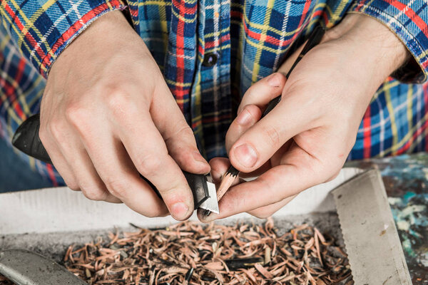 Sharpening a pencil with a stationery knife