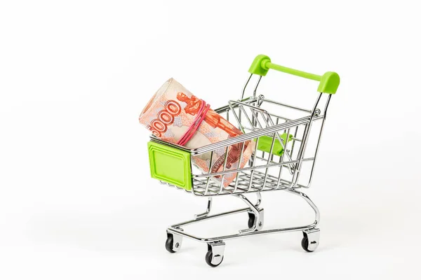 Food trolley, full of Russian 5000 banknotes. On a white background