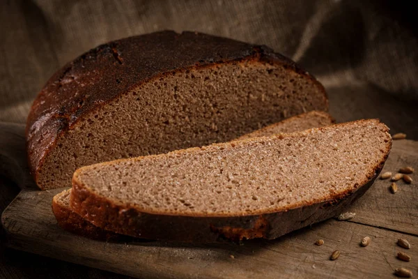 Freshly baked bread cut into chunks on a wooden Board — 스톡 사진