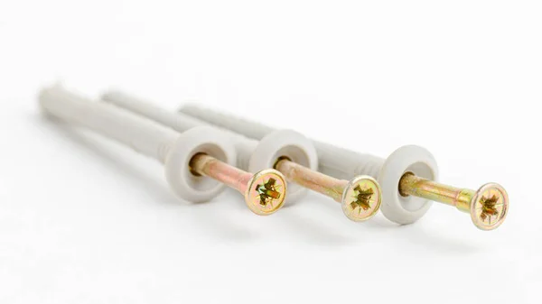Brass metal screws with plastic dowels. — 스톡 사진