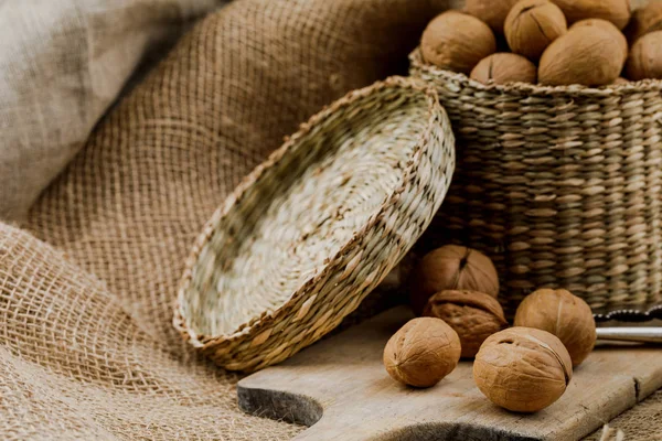 wicker box with walnuts on cutting board