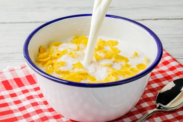 早餐与玉米片 把牛奶倒入装有玉米片的碗里 酸奶飞溅成玉米片 健康的早餐食品和饮料业 — 图库照片