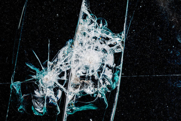 Cracks in car glass on a black background