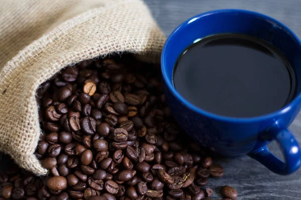 A cup of coffee on coffee beans — Stock Photo, Image