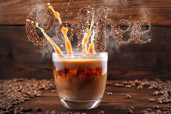 Coffee lettering, Levitating text from coffee beans with steam and splashes from a cup — Stock Photo, Image