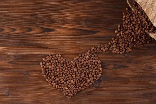Lettering coffee. Coffee beans in the form of a heart coffee, wooden background, i love coffee — Stock Photo, Image