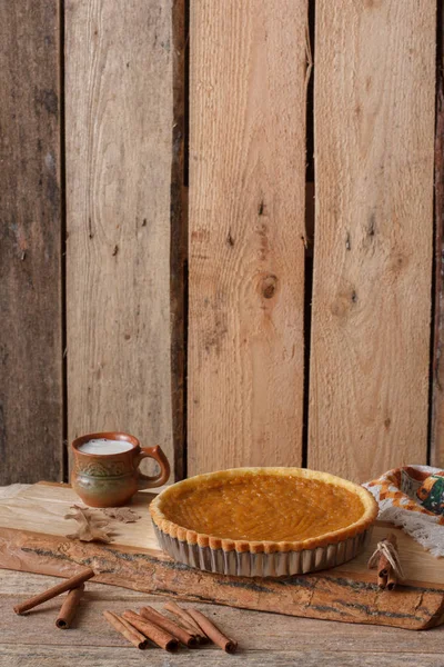 Fresh Homemade Pumpkin Pie made for Thanksgiving. Pie on a wooden background. Rustic. — Stock Photo, Image
