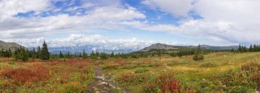 The nature of the Southern Urals. After the rain. Summer in the mountains. Panorama of a beautiful sky with clouds against the backdrop of mountains and forests. clipart
