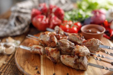 Domuz eti ve taze sebze ahşap arka plan üzerinde şiş kebap. İştah açıcı et bir açık ateş üzerinde pişmiş.