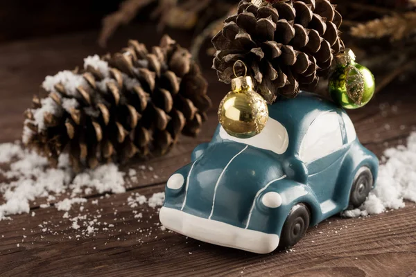 Retro car toy carries a Christmas tree toy. Christmas or New Yea