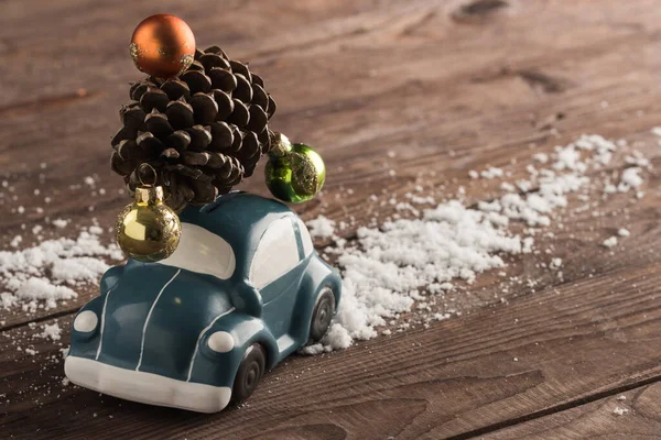 Retro car toy carries a Christmas tree toy. Christmas or New Yea