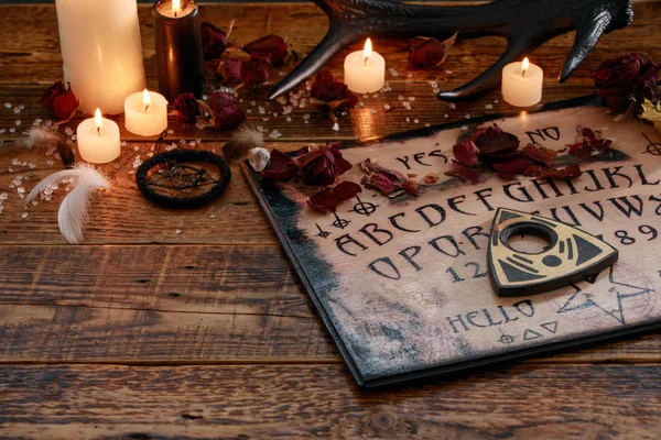 Mystisk ritual med Ouija och ljus. Djävulskoncept, svart magi eller lyckoberättande rit med ockulta och esoteriska symboler. — Stockfoto