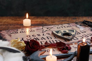 Ouija ve mumlarla mistik ritüeller. Şeytan 'ın tahta konsepti, kara büyü ya da falcılık ayini okült ve esrarengiz sembollerle yapılır..