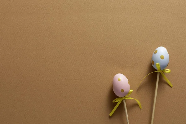 Decorative ornaments in the form of Easter eggs on an orange background. Copy space. Easter holiday concept. Close-up.