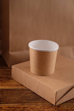 Sokak fast food bardakları, tabaklar ve konteynırlar. Ahşap arka planda çevre dostu gıda ambalajı. Uzayı kopyala Doğanın taşınması ve geri dönüşüm kavramı.