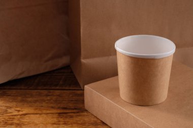 Sokak fast food bardakları, tabaklar ve konteynırlar. Ahşap arka planda çevre dostu gıda ambalajı. Uzayı kopyala Doğanın taşınması ve geri dönüşüm kavramı.