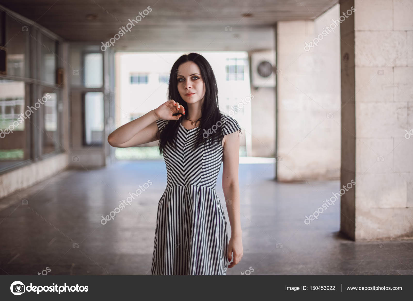 Young Skinny Tall Woman Posing In Short Dress With Stripes