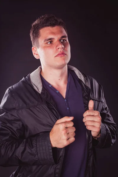 handsome sexy man portrait inside in the studio isolated, looking at the camera, turned his head, seriously experiencing strong eye view