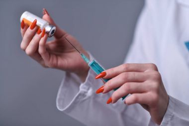 Syringe with medication from the doctor clipart