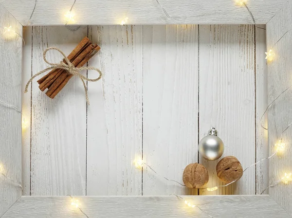 Christmas bright garlands on a wooden light background — Stock Photo, Image