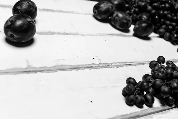 Prunes and grapes on the table — Stock Photo, Image