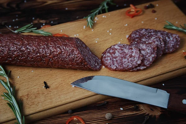 Smoked sausage on a wooden cutting board — Stock Photo, Image