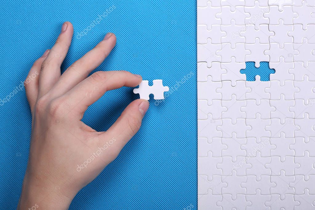 White details of a puzzle on a blue background. A puzzle is a pu