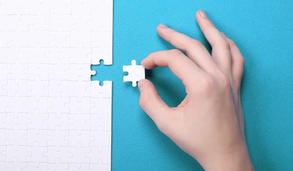 White details of a puzzle on green background. A puzzle is a puz