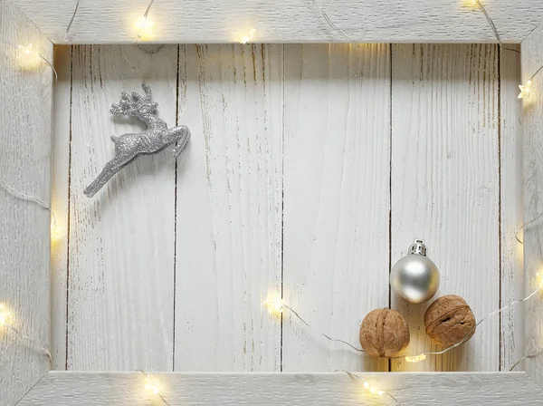 Christmas bright garlands on a wooden light background