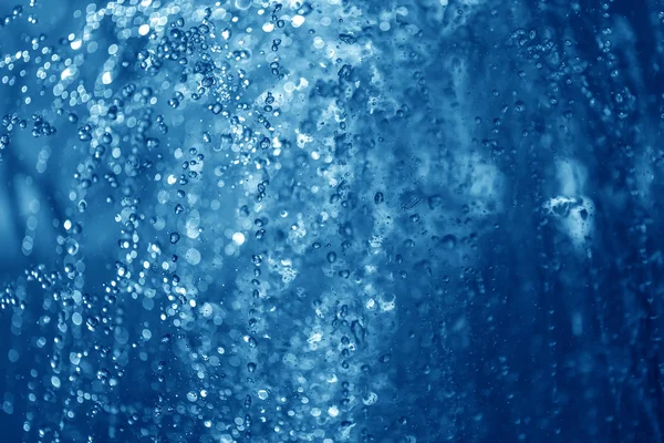 Fontaine de pulvérisation bleue la nuit Image En Vente