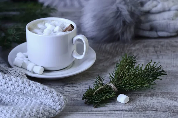 Coffee with marshmallows at the Christmas tree. Festive warming