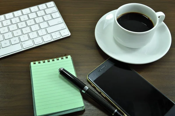 Working desk table with black coffee cup. Top view with copy space