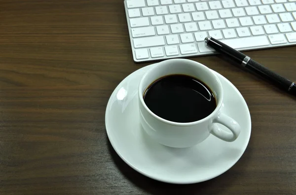 Working desk table with black coffee cup. Top view with copy space