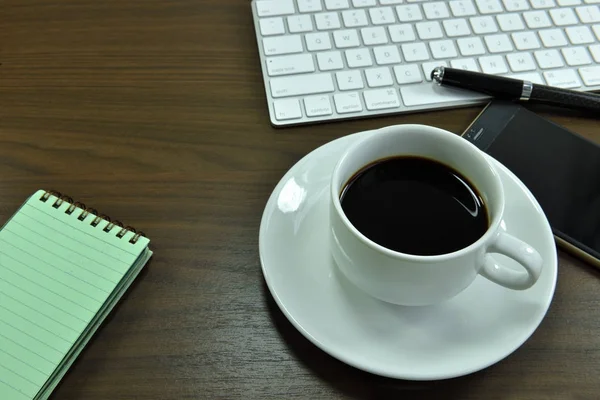 Working desk table with black coffee cup. Top view with copy space